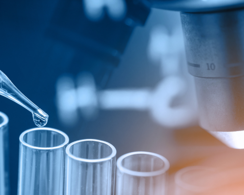 Peptides for research labs — laboratory scientist recording results beside a microscope