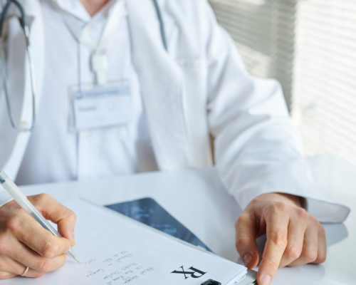 Peptides for physicians — physician in a white coat reviewing supplier paperwork at a desk