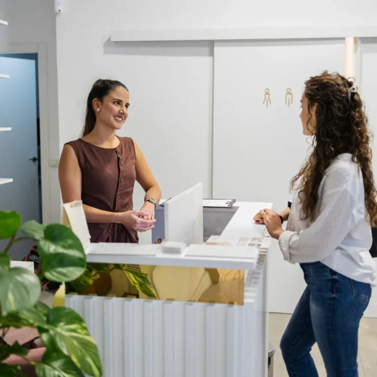 Wellness clinic front desk with a patient checking in